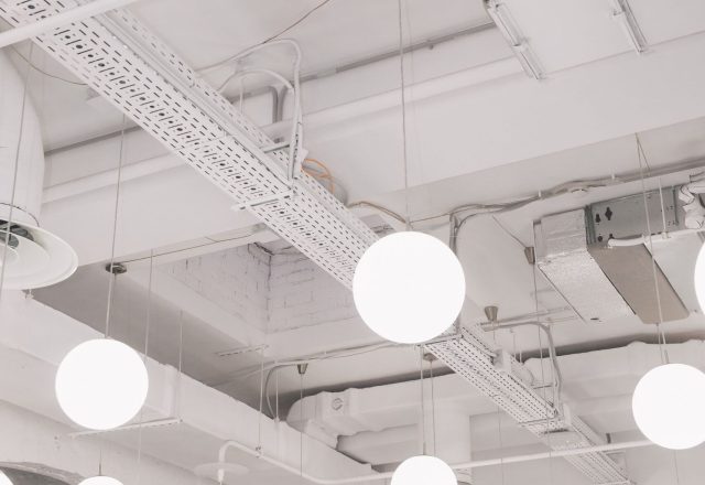 Modern pendant lighting installed in a commercial office space