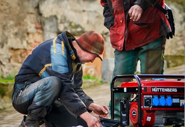 Technicians working on a standby power generator